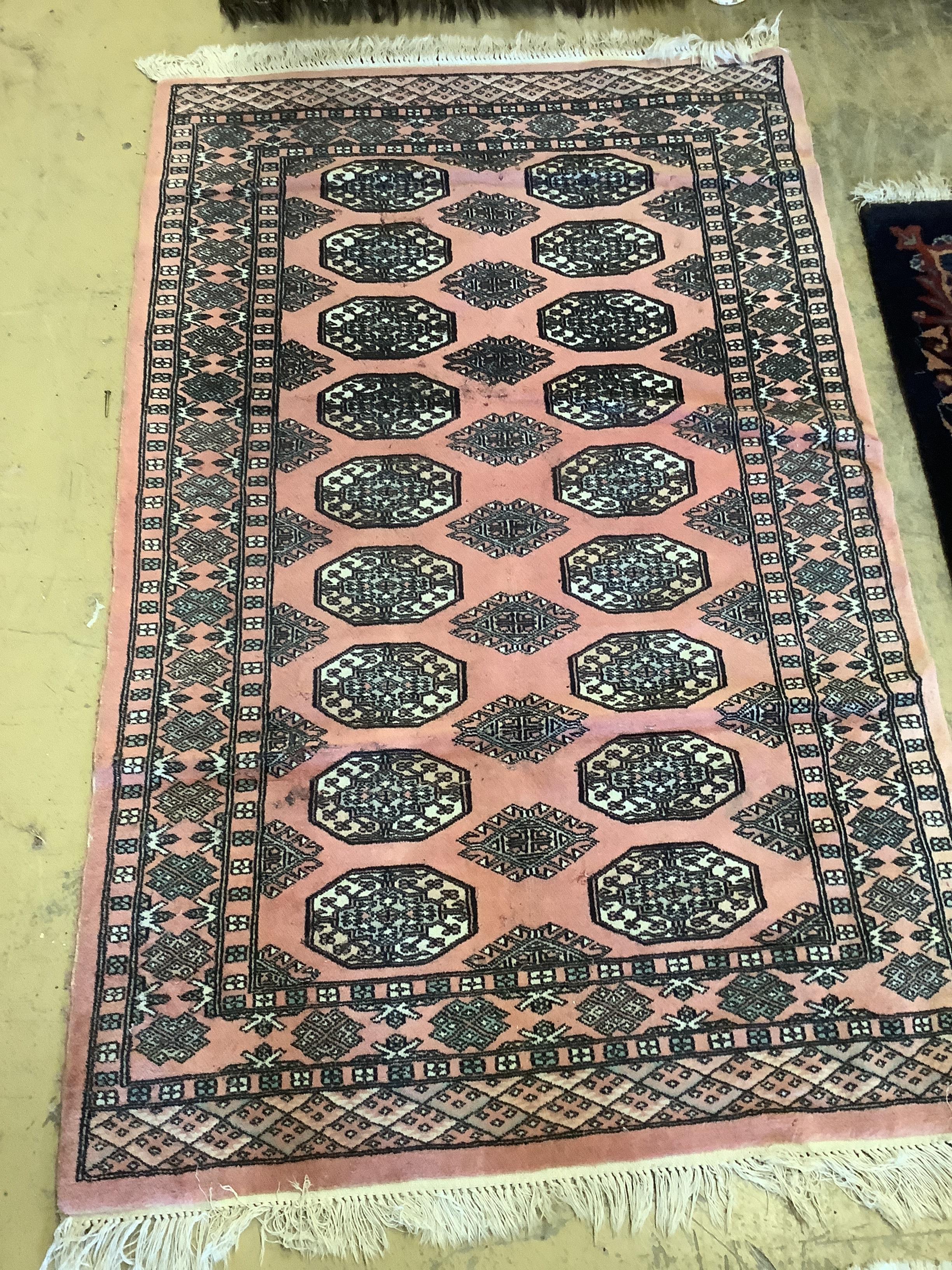 A Bokhara peach ground runner, 310 x 83cm together with a similar rug